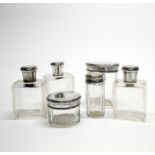 A group of six continental silver topped dressing table items.