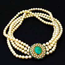 A four strand cultured pearl necklace with a yellow metal (tested minimum 9ct gold) clasp set with