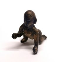 An 18th/19thC Indian bronze figure of the baby Krishna with glass eyes, H. 7cm.