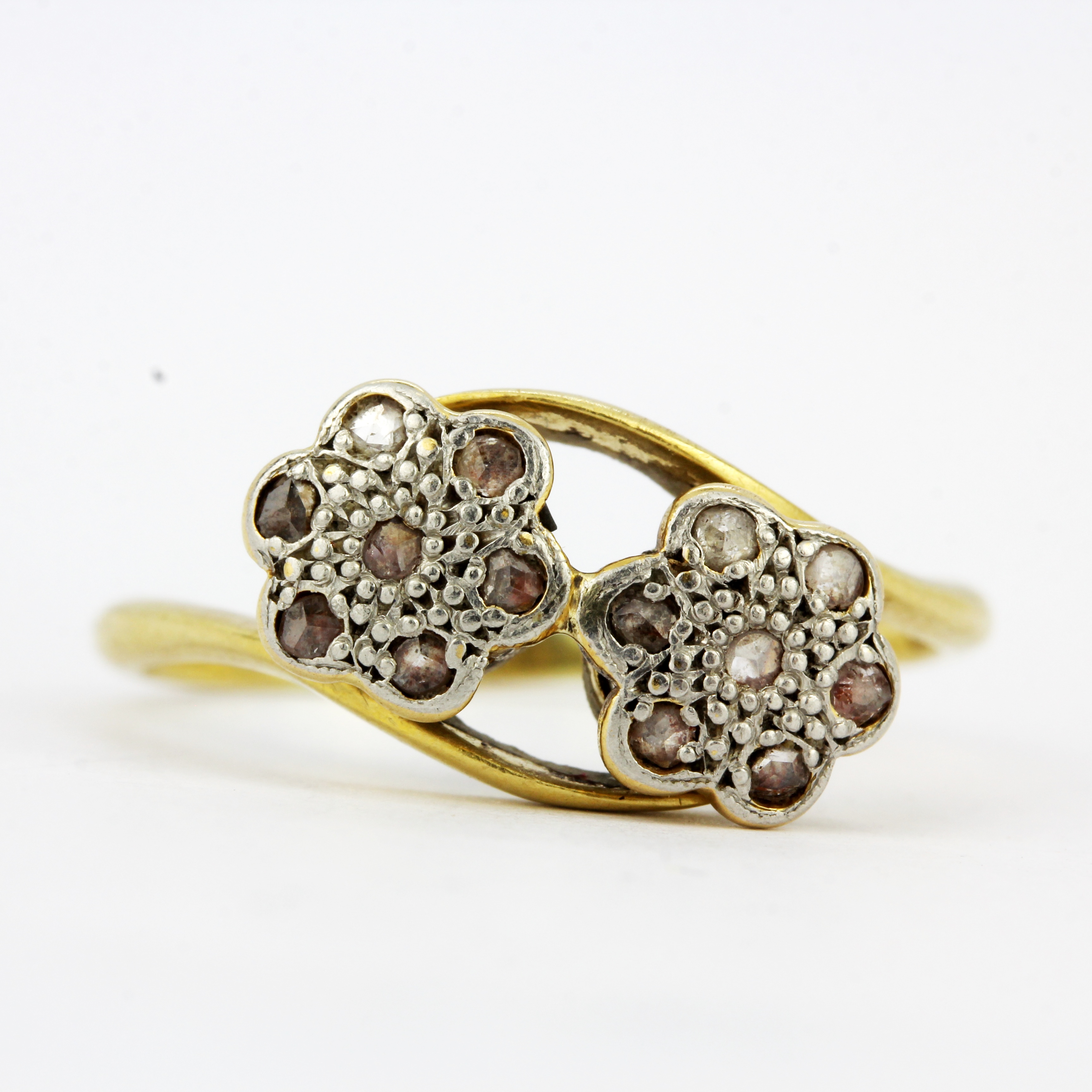 An 18ct gold and platinum diamond set crossover ring, (P.5).