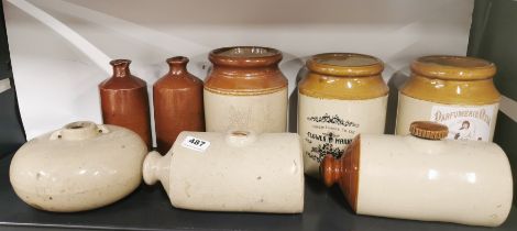 A group of stoneware jars and hot water bottles.