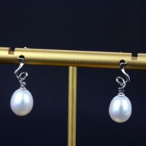 A pair of 9ct white gold pearl set drop earrings, L. 1.8cm.