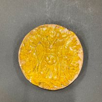 A small Oriental yellow glazed sasaniak tile c. 226-651 AD, Dia. 10cm.
