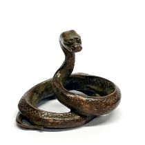 A Chinese cast bronze figure of a coiled snake, H. 4.5cm, W. 5.5cm.