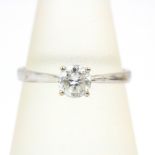 A 9ct white gold stone set solitaire ring, (L.5).