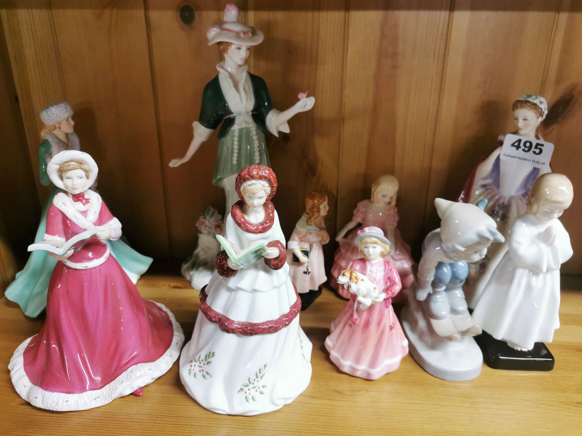 A group of Royal Doulton and other figurines.