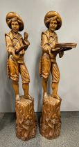 A pair of large continental carved wooden figures c.1920's, H. 118cm. Some restoration.