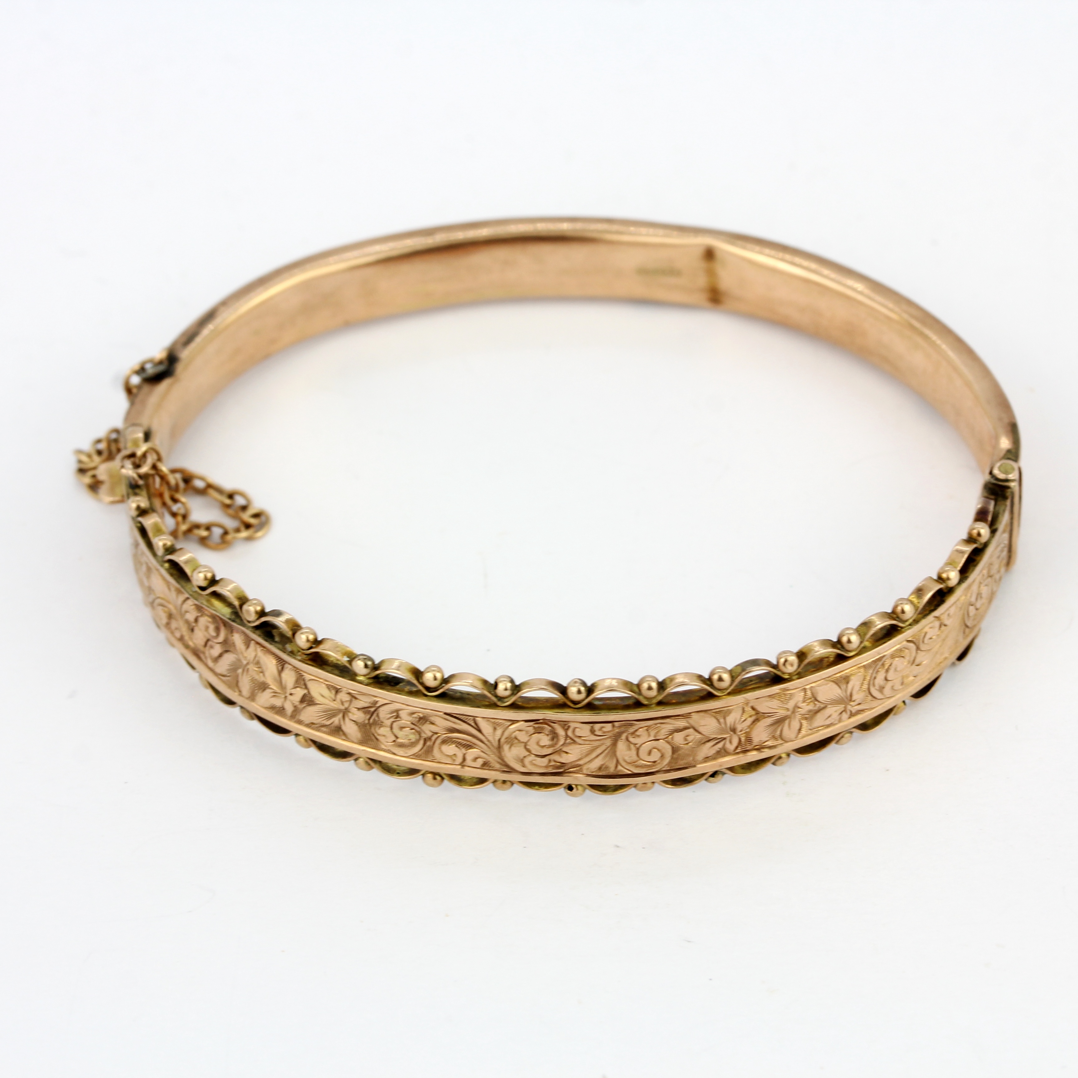 A hallmarked 9ct rose gold bangle, internal size 5.5 x 4.5cm. Some dents. - Image 2 of 3