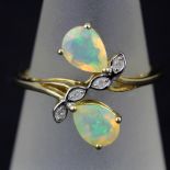 A 9ct yellow gold ring set with pear cut opals and diamonds, (O)