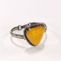 A white metal (tested silver) and amber bracelet, W. 4cm, D. 4.2cm.