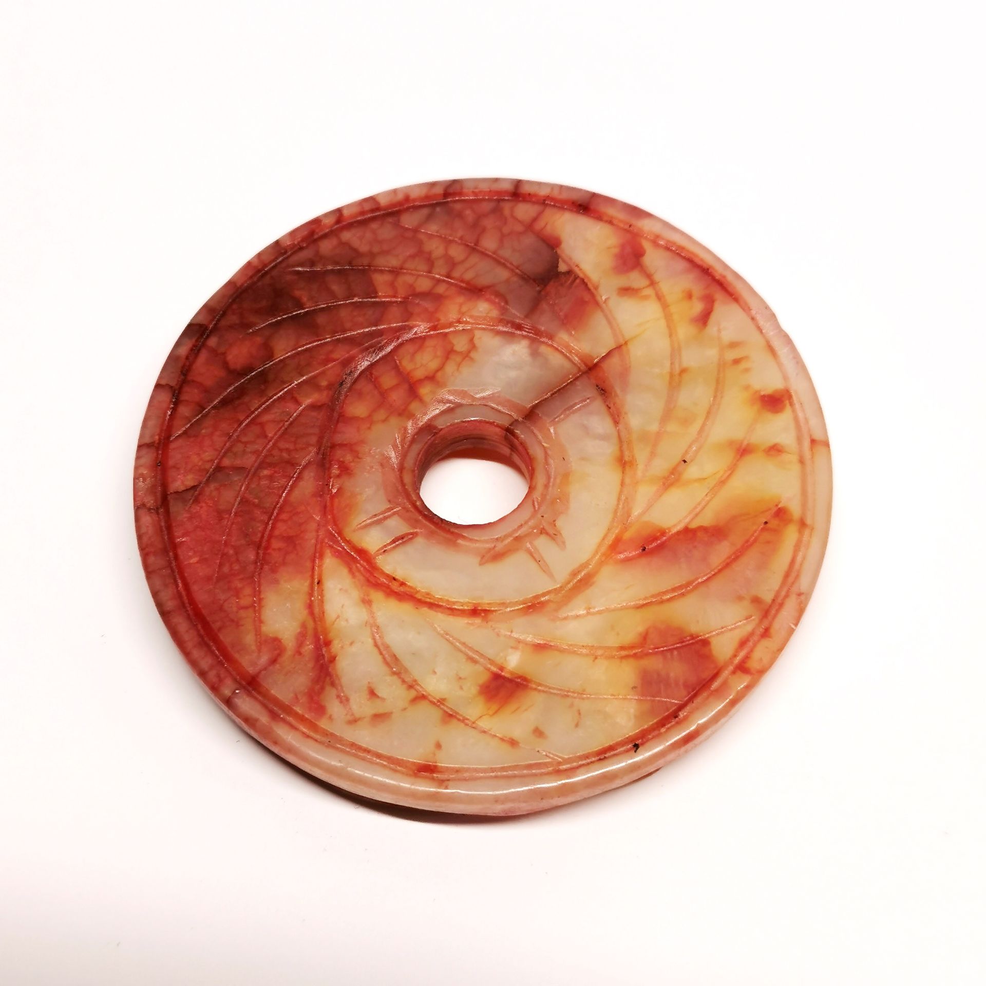 A small Chinese carved jade disc, dia. 5.5cm. - Image 2 of 2