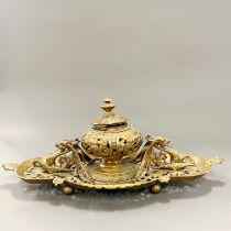 A heavy ornate brass inkwell, W. 40cm.