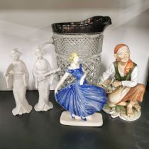 Four porcelain figures and a large glass lemonade jug, jug H. 23cm.