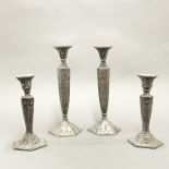 Two pairs of hexagonal silvered brass candlesticks with relief decoration, tallest H. 31cm.