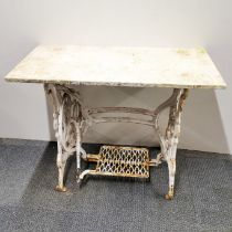 A cast iron treadle sewing machine table adapted for use as a garden table with later added