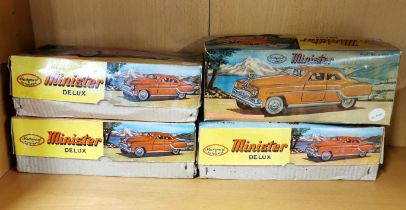 Four boxed tin toy cars, L. 23cm.