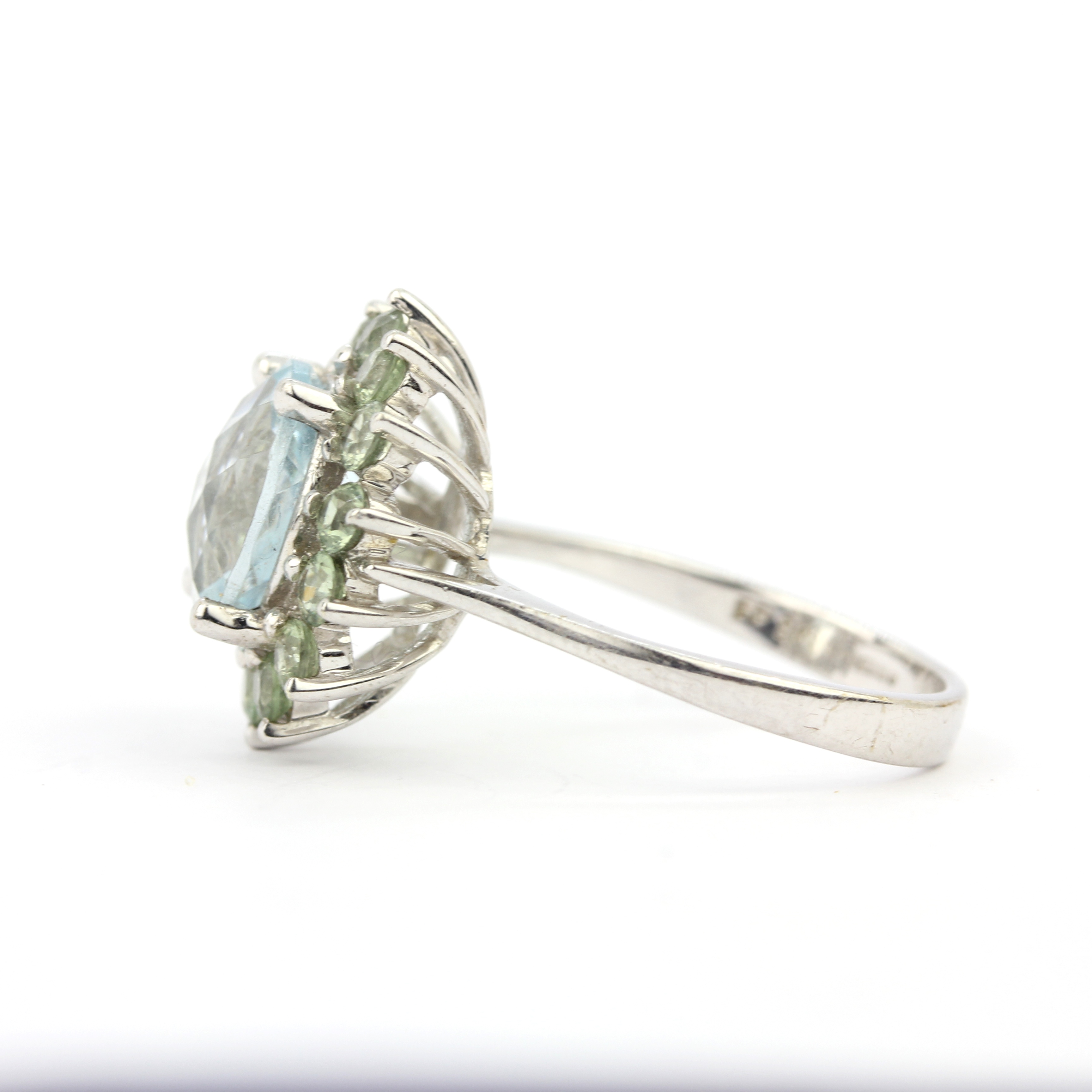 A 9ct white gold ring set with checker board cut aquamarine surrounded by green amethyst, (P). - Image 2 of 3
