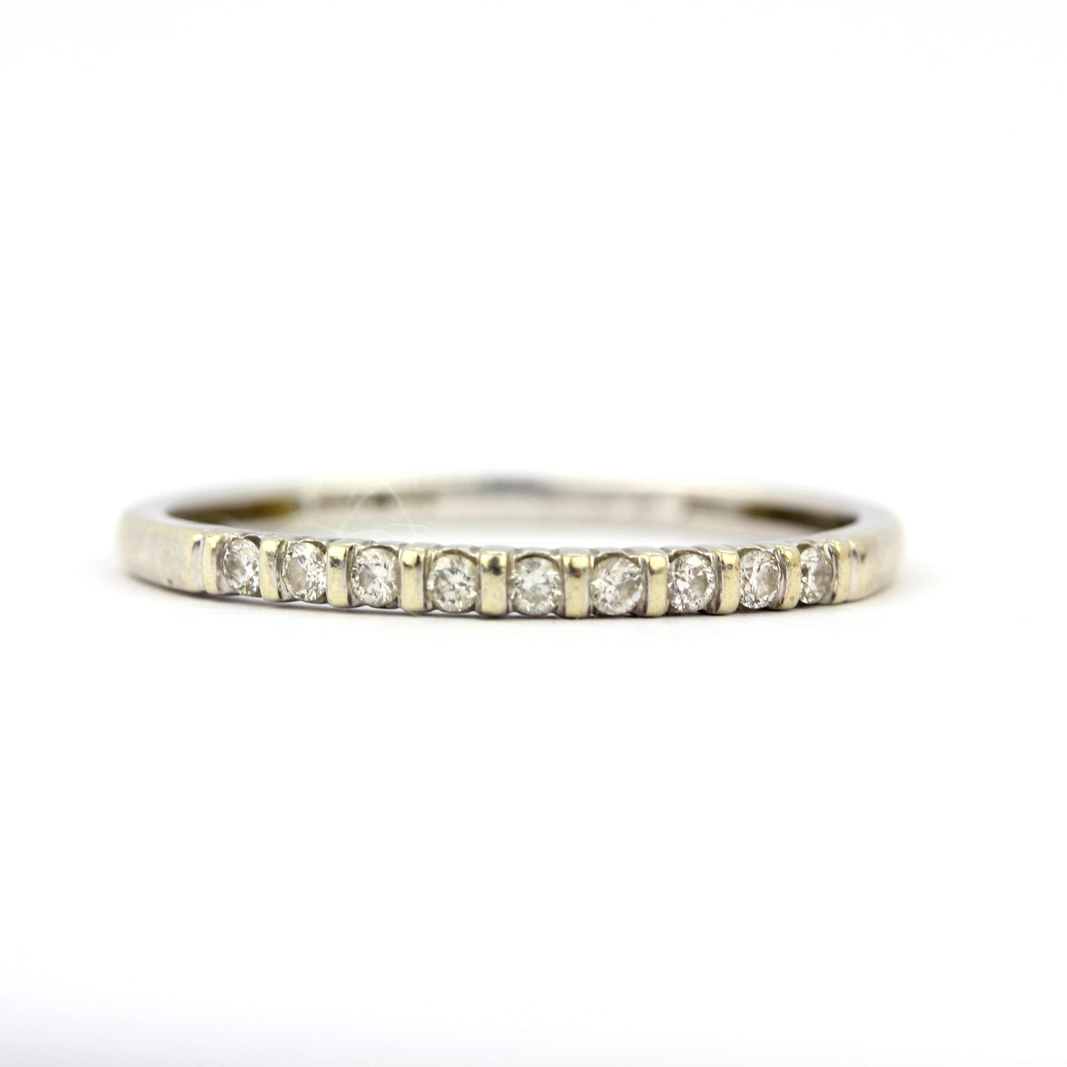 A 9ct white gold diamond set half eternity ring, (P.5).