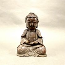 A Chinese cast bronze figure of a seated Buddha, H. 23cm.