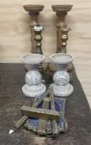 Three pairs of candlesticks and three metal and wooden frames.