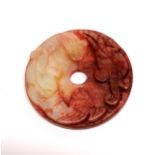 A small Chinese carved jade disc, dia. 5.5cm.