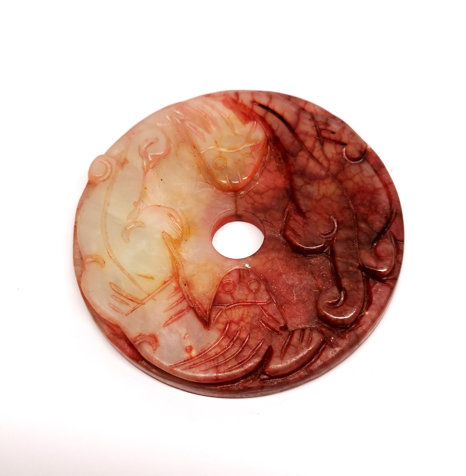 A small Chinese carved jade disc, dia. 5.5cm.