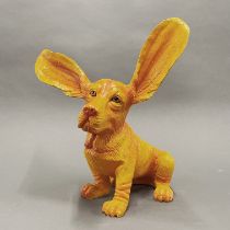 An orange painted composition figure of a dog with very perky ears, H. 34cm, ear L. 17cm.