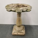 An antique carved sandstone bird bath, H. 70cm Dia. 50cm.