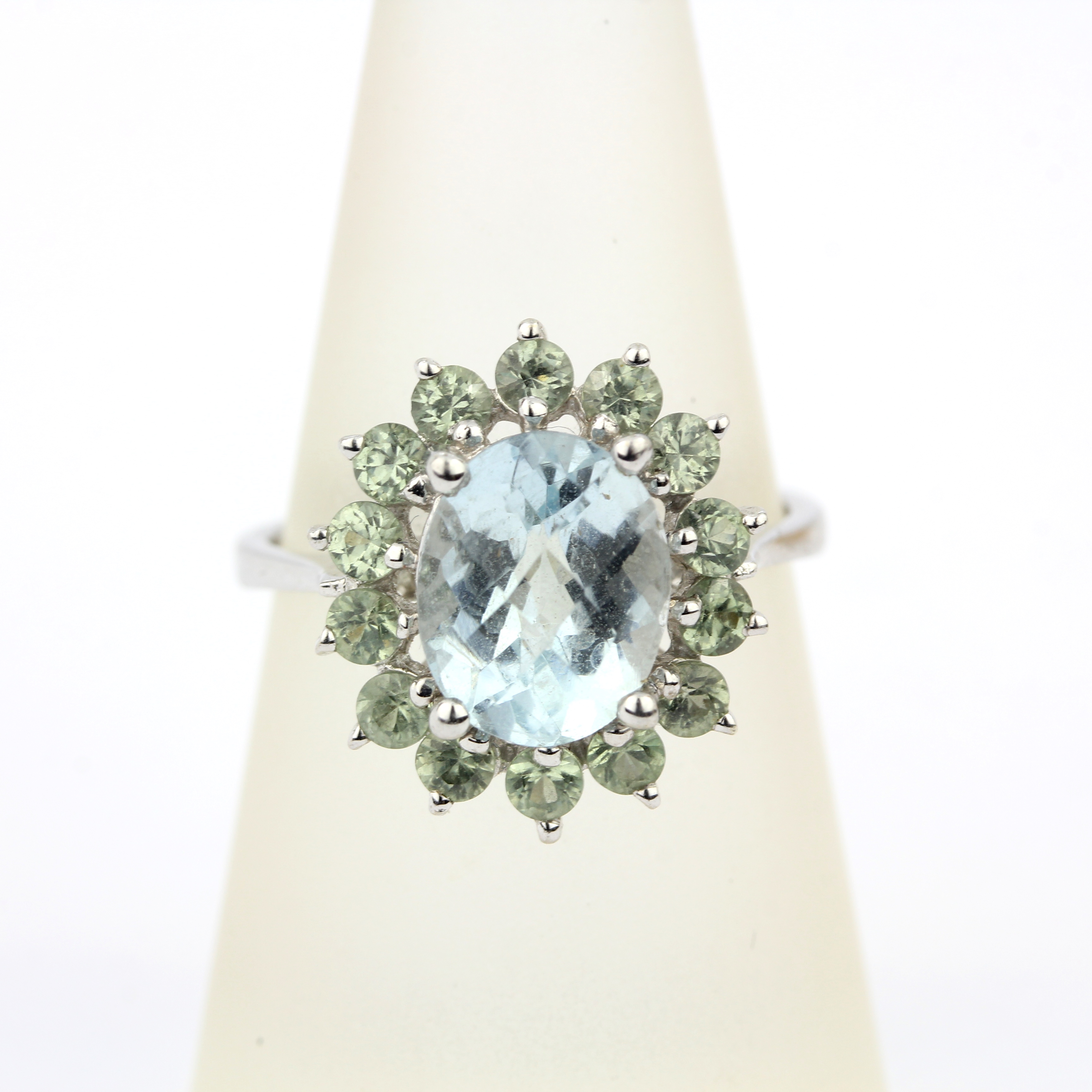 A 9ct white gold ring set with checker board cut aquamarine surrounded by green amethyst, (P). - Image 3 of 3