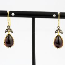 A pair of 9ct gold and silver drop earrings set with pear cabochon garnets and diamonds, L. 3cm.