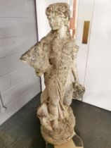 A large antique carved stone garden figure of a woman carrying baskets, H. 136cm base W. 40cm.