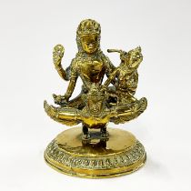 A 19th century North Indian brass deity figure, H. 14cm.