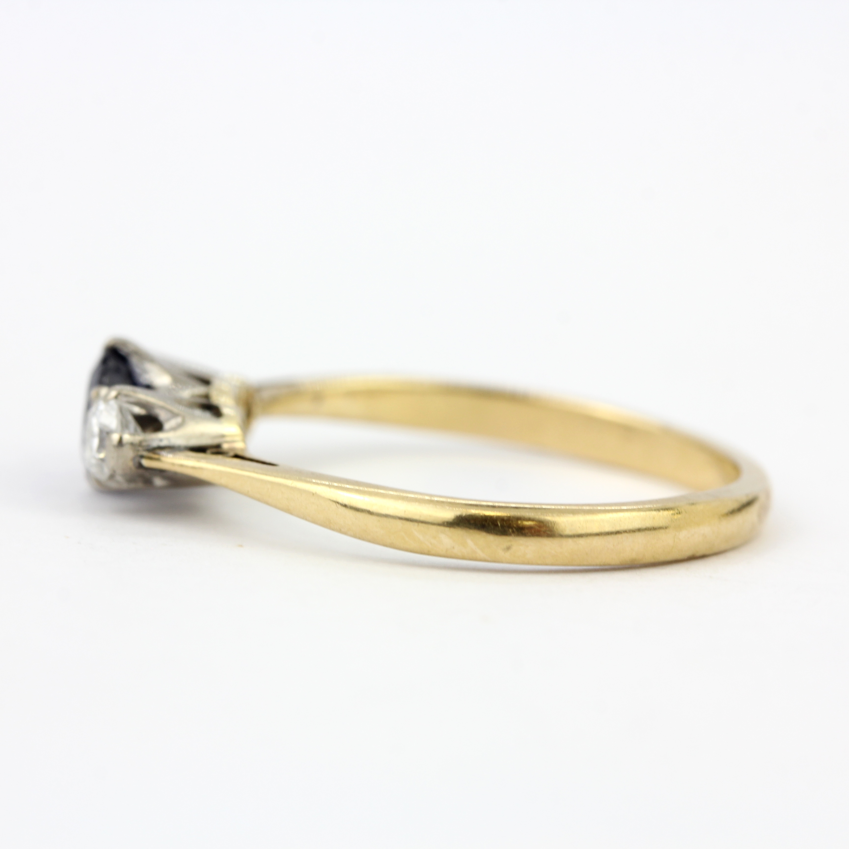 An 18ct yellow gold (stamped 18ct) ring set with a sapphire flanked by diamonds, (N.5). - Image 2 of 3