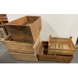 A group of five vintage wooden crates, largest 74 x 38 x 29cm, and tins.