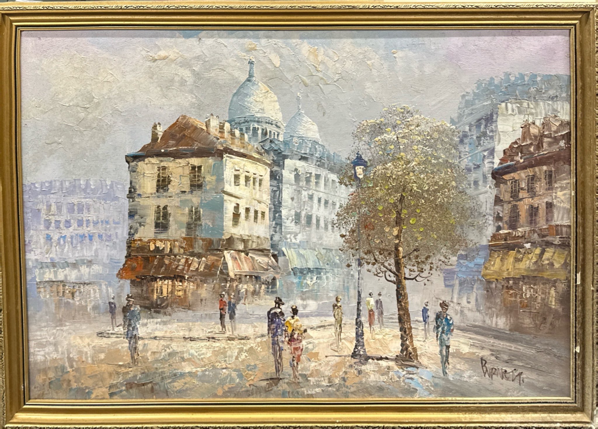 A 1970's gilt framed oil on canvas of a street scene signed Burnett, frame size 82 x 57cm.