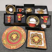 A group of mostly boxed Versace porcelain items.