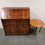 A nine drawer oak bureau, together with a circular oak side table, bureau 97 x 92 x 46cm.