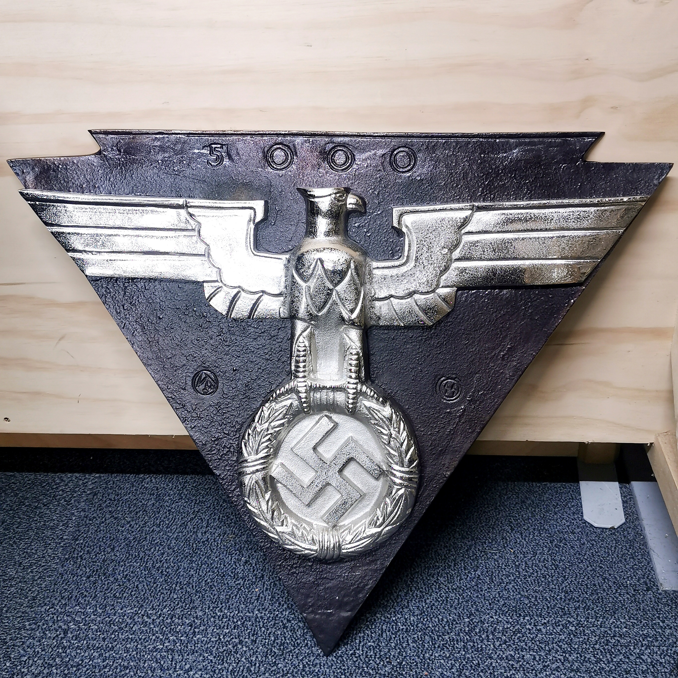 A large metal German reproduction wall insignia, W. 66cm H. 56cm.