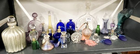 A collection of coloured glass perfume bottles including a blue glass perfume bottle with R. Lalique