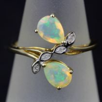 A 9ct yellow gold ring set with pear cut opals and diamonds, ring size