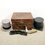 A antique gentlemen's leather hat box, with top hat by Scotts of London with gloves and brush. Noted