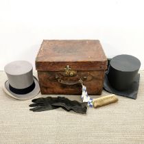 A antique gentlemen's leather hat box, with top hat by Scotts of London with gloves and brush. Noted
