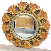 A large circular carved wooden mirror, Dia 75cm.