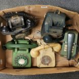 A group of five vintage telephones.