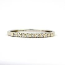 A 9ct white gold diamond set half eternity ring, (P.5).