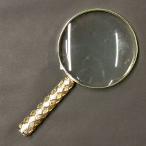 A large gilt brass magnifying glass, size 29cm.