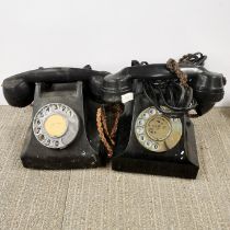 Two black bakelite telephones.