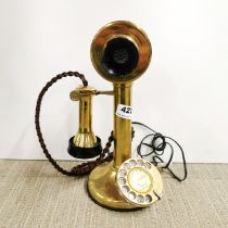 A brass stick telephone.