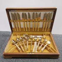 A boxed gold plated cutlery set, twelve settings.