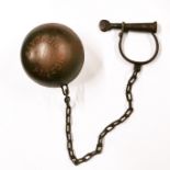 A cast iron reproduction ball and chain. Ball Dia. 15cm.